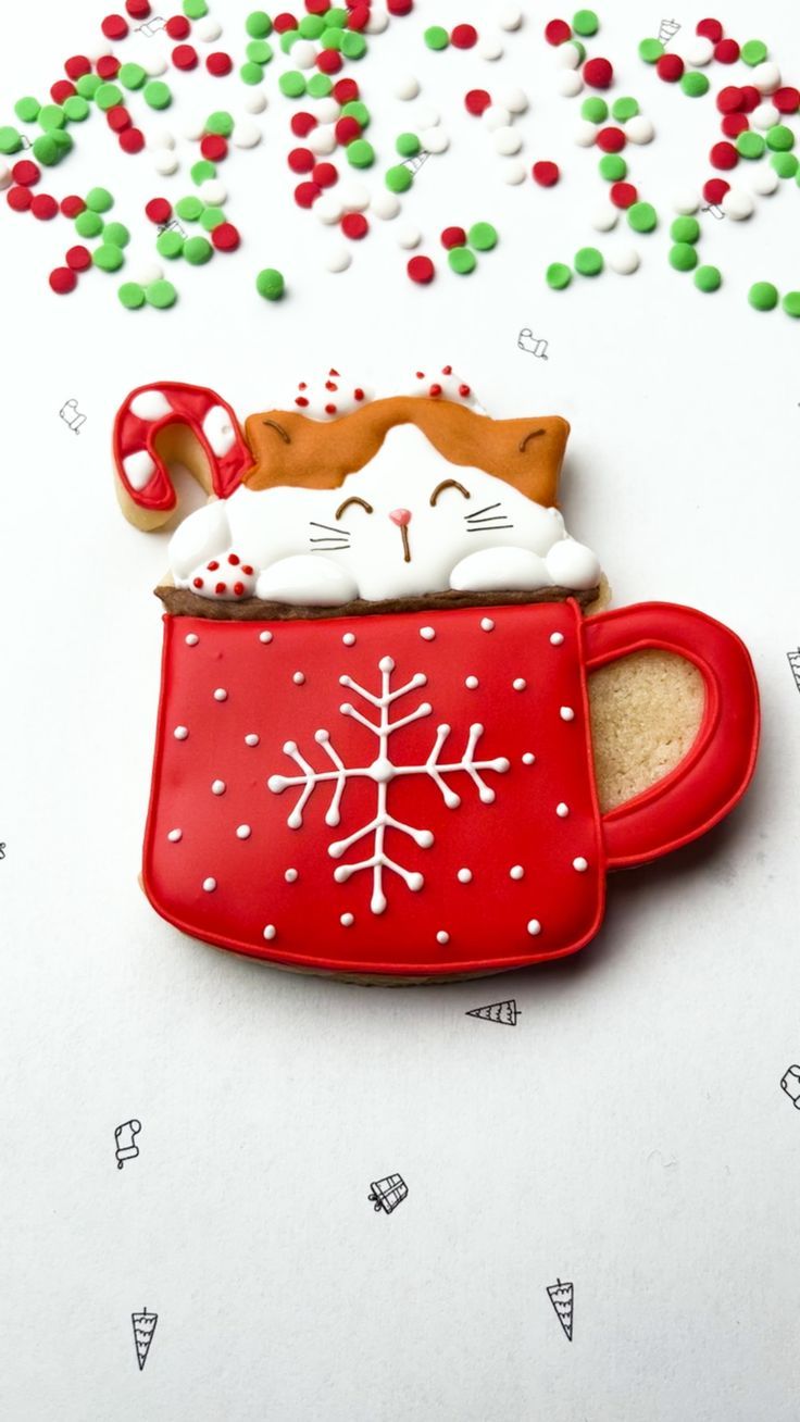 Whimsical Holiday Cookie Design: Cheerful Cat in a Red Mug with Whipped Cream and Candy Cane