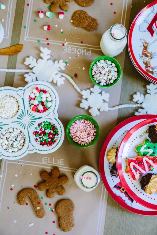 Creative Holiday Cookie Decorating Setup with Colorful Sprinkles and Gingerbread Shapes.