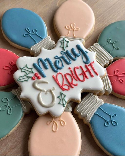 Whimsical Holiday Cookie Display: Pastel Light Bulb Designs with Elegant Script Centerpiece.