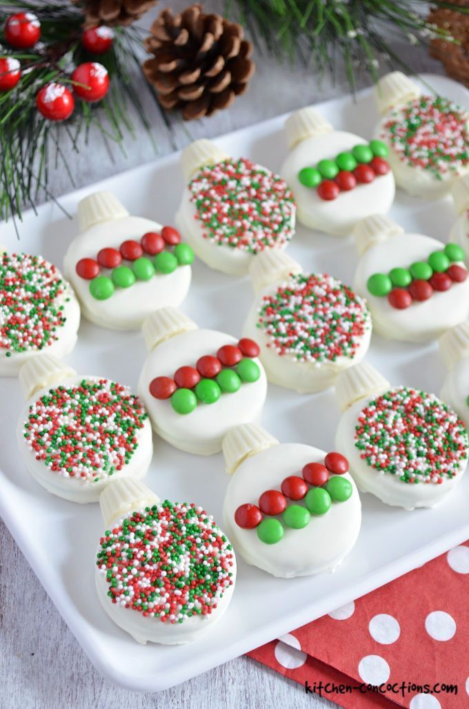 Charming Christmas Ornament Cookies Dipped in White Chocolate and Sprinkled with Festive Colors.