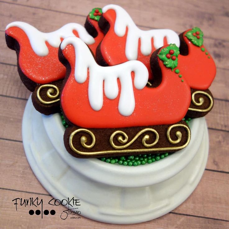 Vibrant Sleigh-Shaped Holiday Cookies with Festive Red and White Icing.