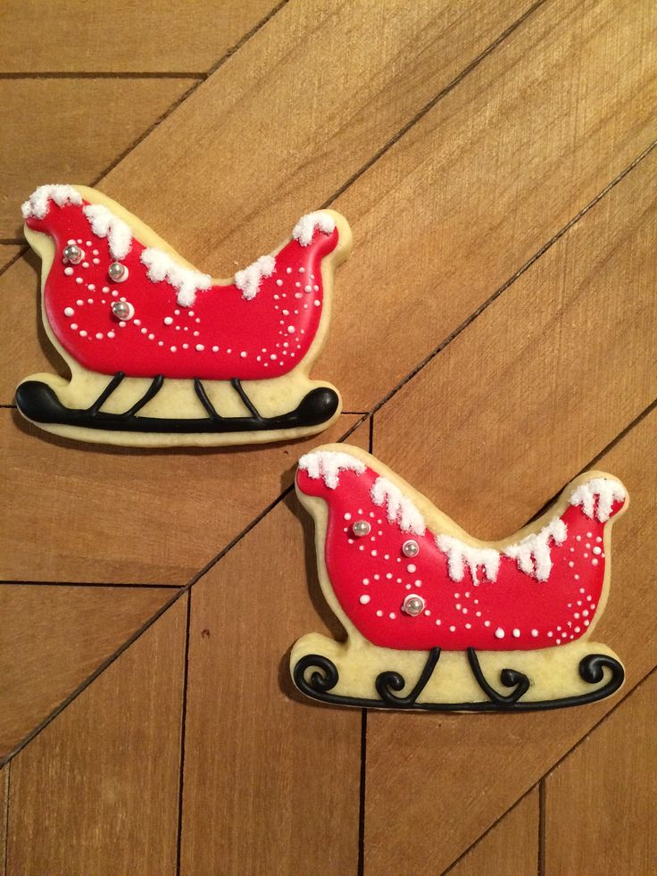 Festive Sleigh-Shaped Cookies with Vibrant Icing and Elegant Accents.