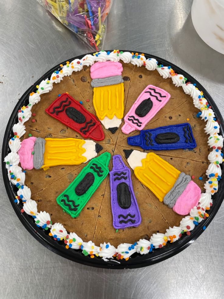 Vibrant Crayon-Shaped Cookie Cake with Whipped Cream and Festive Toppings.