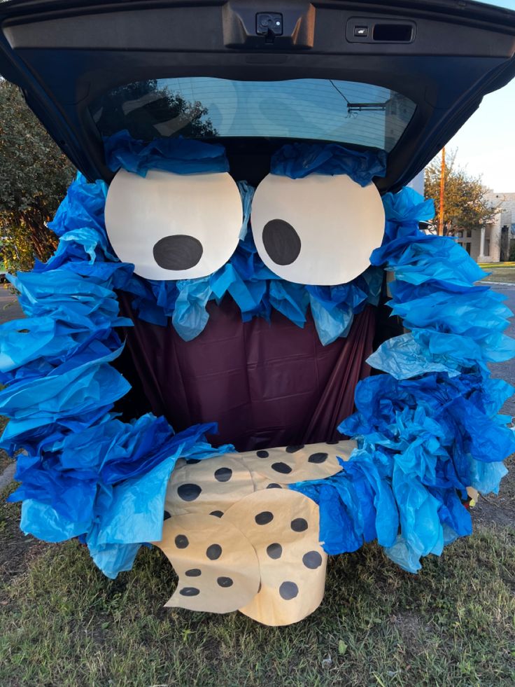 Whimsical Animated Character Car Decoration with Fluffy Blue Texture and Polka-Dotted Base.