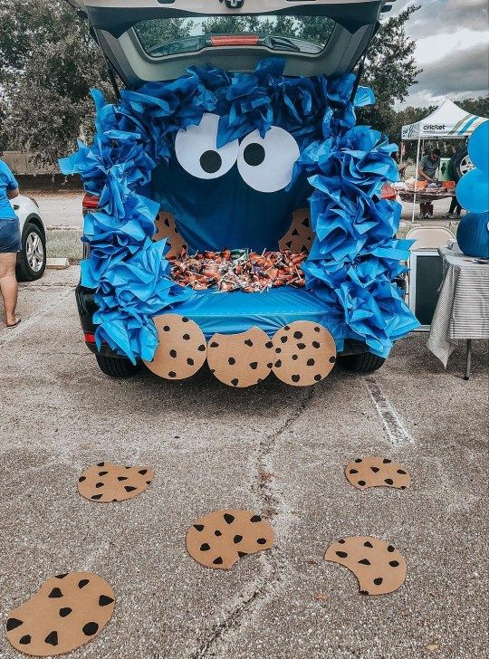 Playful Blue-Themed Car Trunk Design with Whimsical Backdrop and Festive Cookie Cutouts.