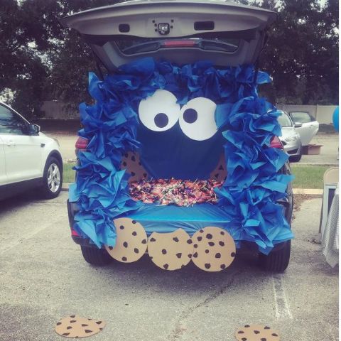 Whimsical Cookie Monster-Themed Car Decoration with Vibrant Blue Tissue and Oversized Cookie Cutouts.