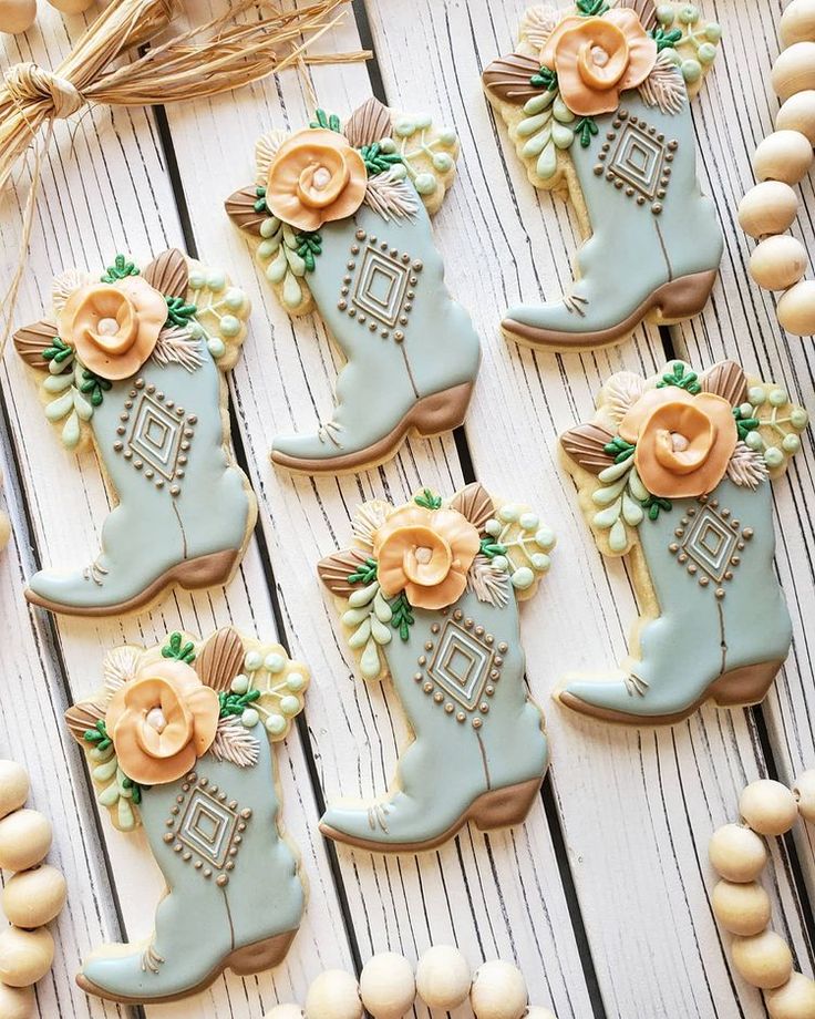 Charming Cowboy Boot Cookies with Pastel Floral Designs for Themed Celebrations.