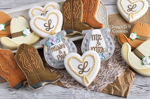 Elegant Western-Themed Decorative Cookies with Intricate Icing and Pastel Floral Accents.