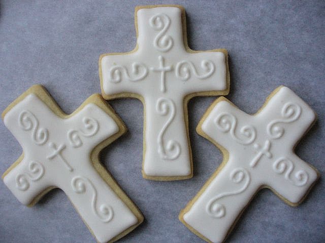 Elegant Cross-Shaped Cookies with Intricate Icing for Religious Celebrations.