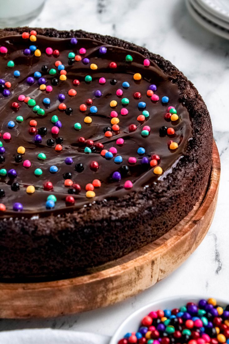 Decadent Chocolate Cake with Colorful Sprinkles on a Rustic Platter