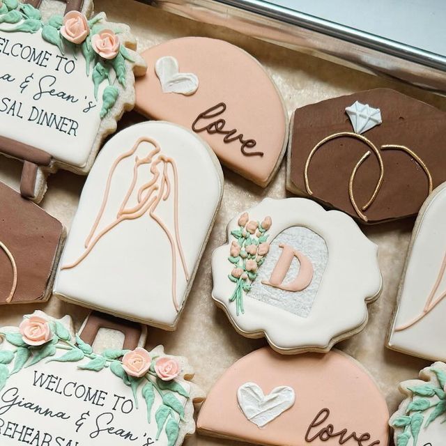 Romantic-Themed Decorated Cookies for Special Occasions in Elegant Designs.