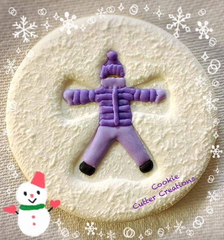 Cheerful Winter-Themed Decorative Cookie Featuring a Snowman in Purple Attire.