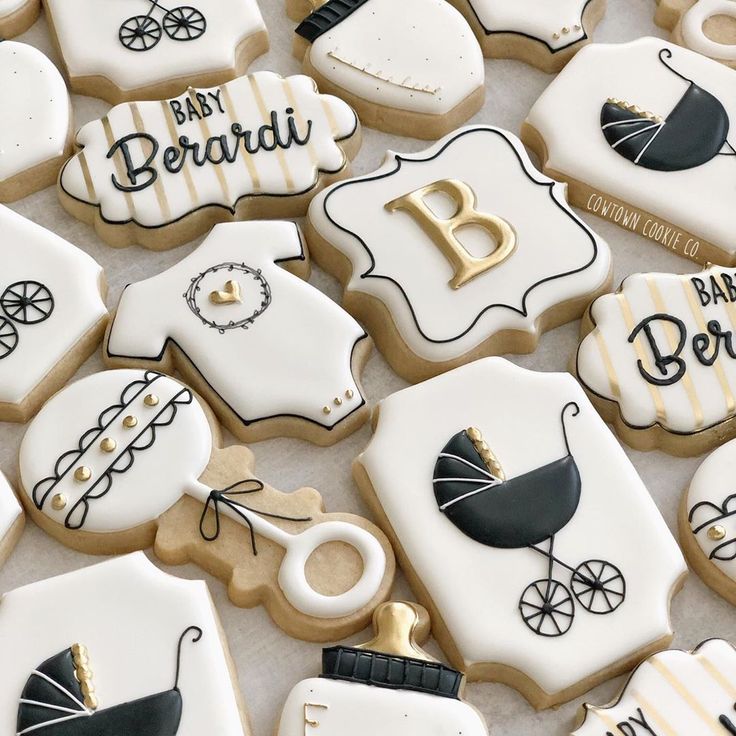 Elegant Decorative Cookies with Intricate Baby-Themed Designs in Pastel Colors.