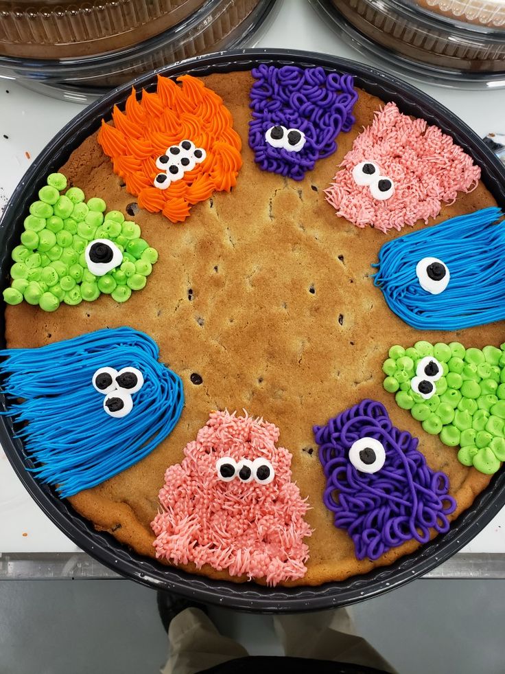 Whimsical Colorful Cookie Cake with Playful Icing Monster Characters.