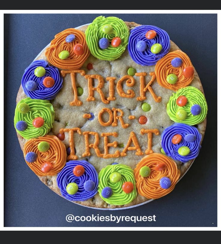 Vibrant Halloween Cookie Cake: A Festive Centerpiece with Colorful Frosting and Candy Embellishments.