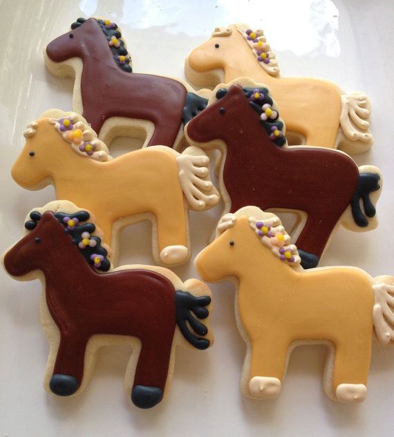 Whimsical Horse-Shaped Cookies Inspire Playful Nail Design with Vibrant Icing and Colorful Accents.