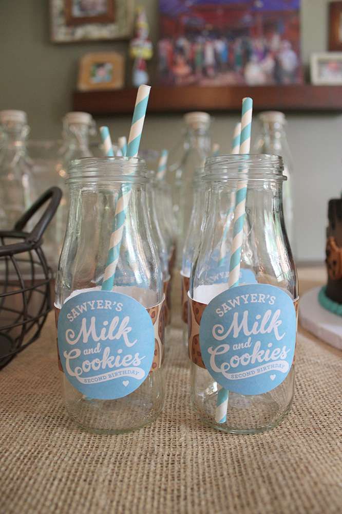 Delightful Glass Milk Bottles with Striped Straws Enhance Cookies and Milk-Themed Birthday Celebration.