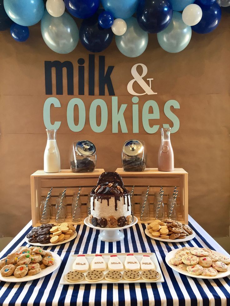 Festive Dessert Table with Colorful Cookies, Elegant Cake, and Milk Containers