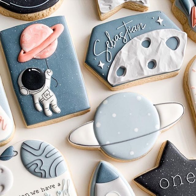 Vibrant Whimsical Space-Themed Cookies with Intricate Designs and Playful Figures.