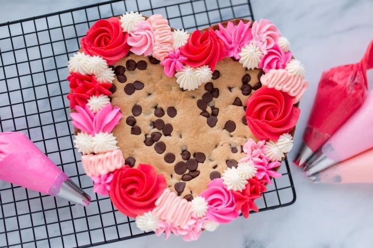 Festive Heart-Shaped Cookie Adorned with Vibrant Frosting and Chocolate Chips for Celebrations.