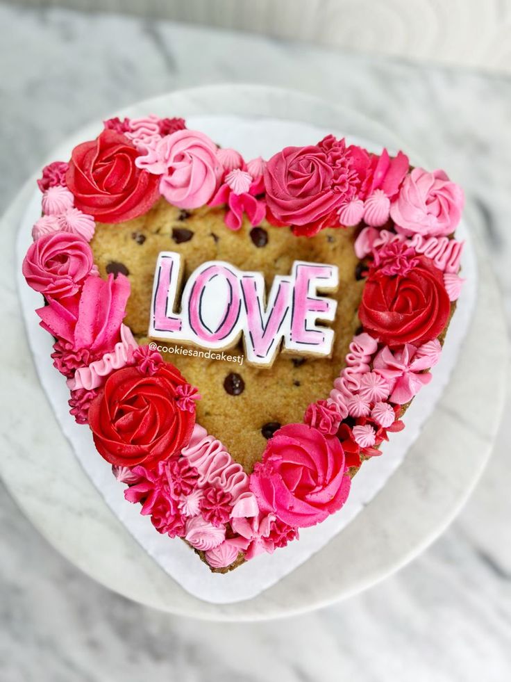 Romantic Heart-Shaped Cookie Cake with Vibrant Frosting Flowers for Celebrations.