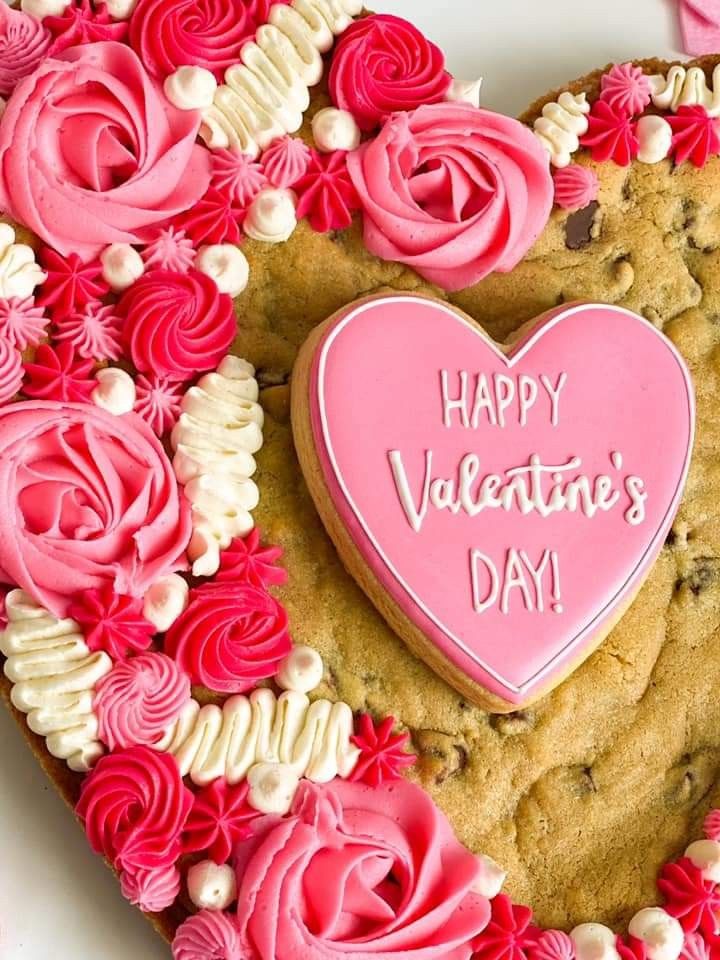 Romantic Heart-Shaped Cookie Cake with Elegant Pink and White Icing for Valentine's Celebrations.