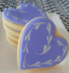 Elegant Heart-Shaped Cookies: A Whimsical Treat with Sophisticated Lavender Icing.