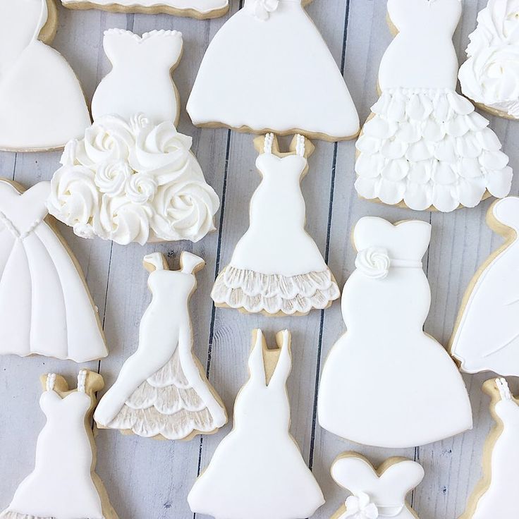 Charming Dress-Shaped Cookie Decorations with Intricate Floral Designs for Special Occasions.