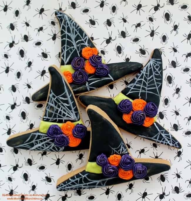 Whimsical Halloween Witch Hat Cookies with Spiderweb Icing and Colorful Rose Decorations