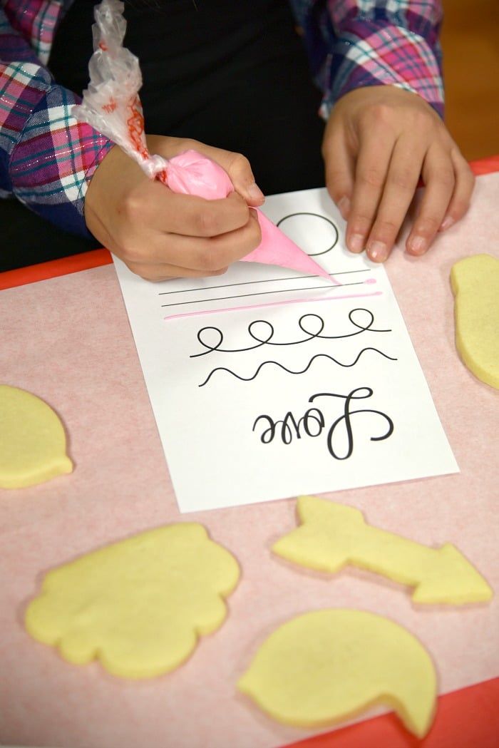 Artistic Cookie Decorating: Intricate Icing Designs in Progress.