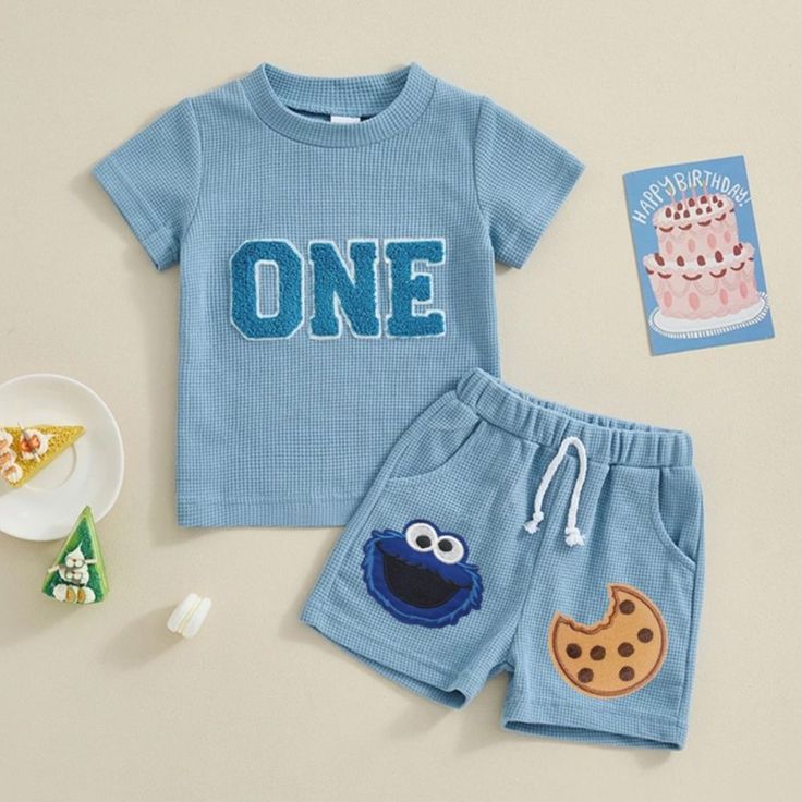 Charming Toddler Outfit: Blue Ribbed T-Shirt and Playful Patch Shorts Ideal for Birthdays or Playdates.