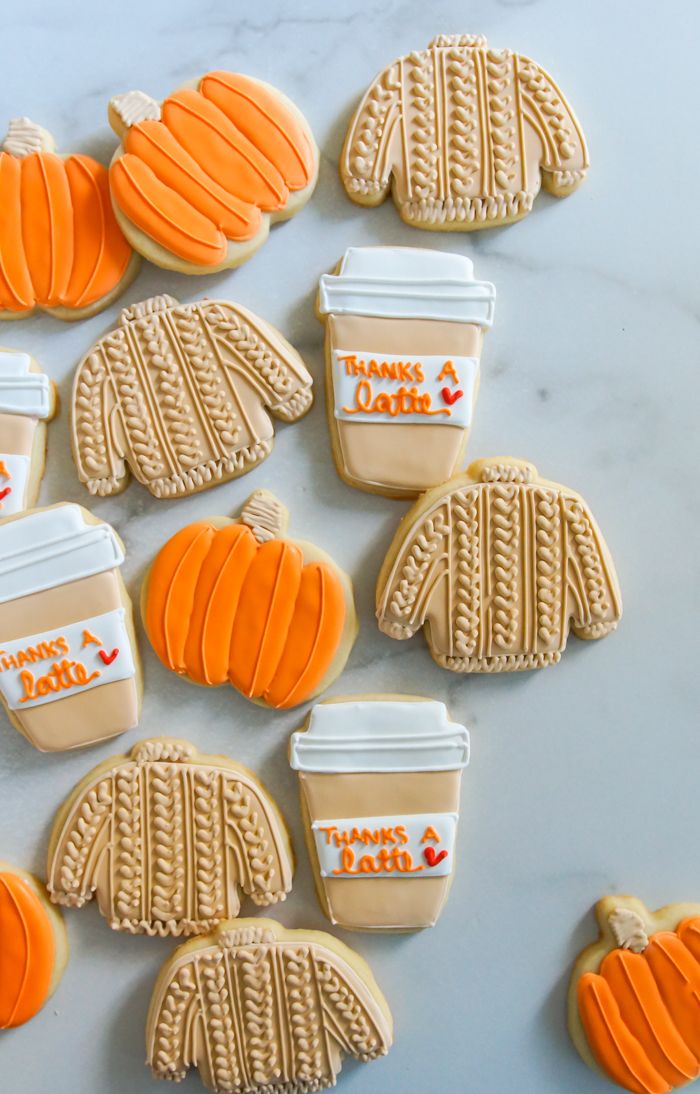 Charming Autumn-Themed Cookies: Cozy Sweater Shapes, Pumpkins, and Whimsical Coffee Cups.