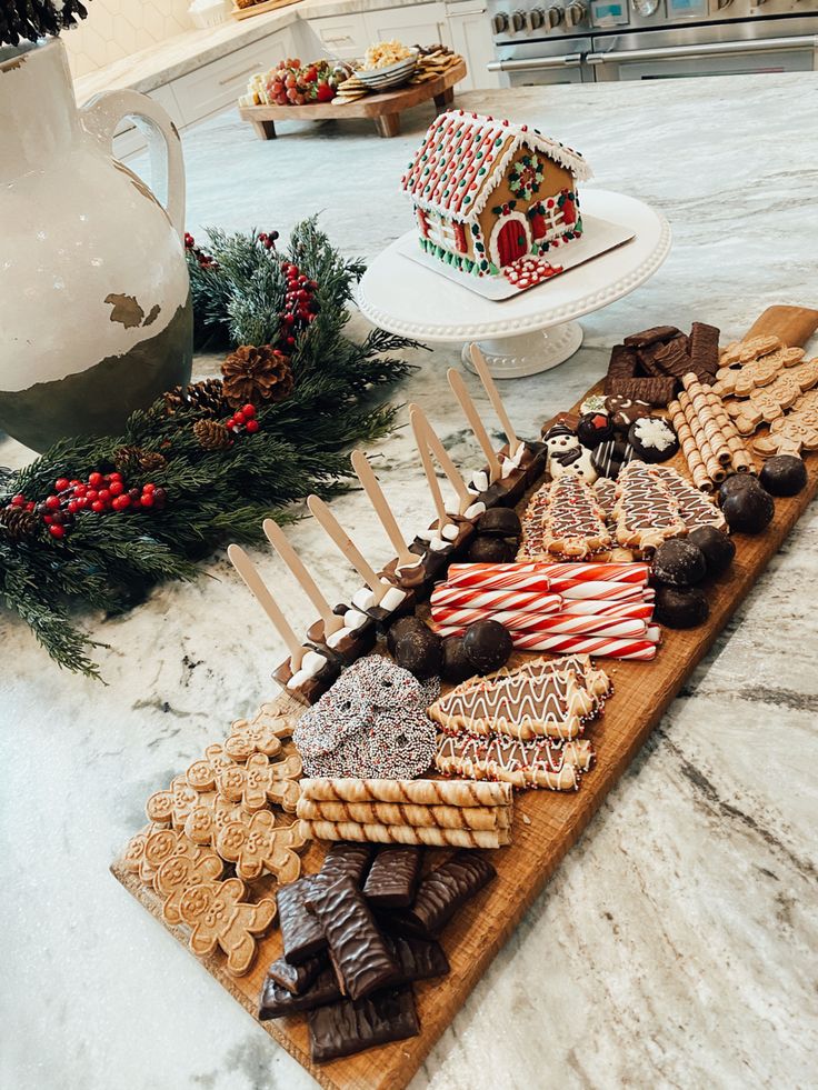 Festive Dessert Platter Featuring Chocolates, Cookies, and Gingerbread House for Celebrations.