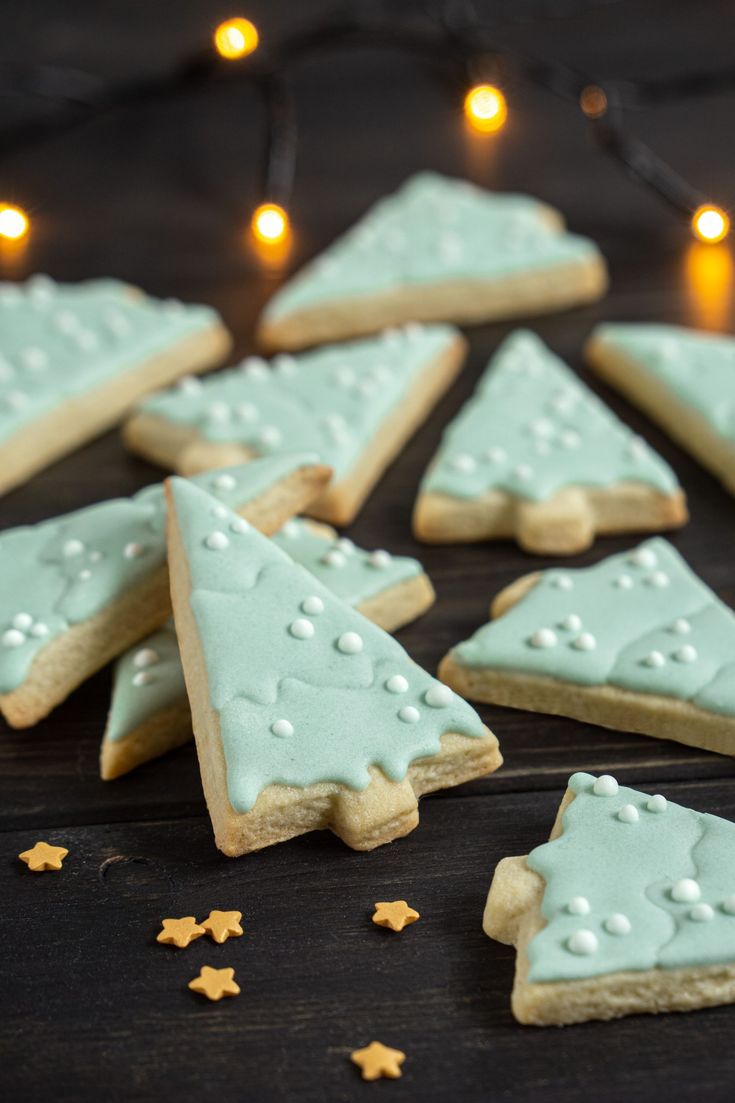 Whimsical Pastel Blue Christmas Tree Cookies Adorned with Icing Dots and Twinkling Lights.