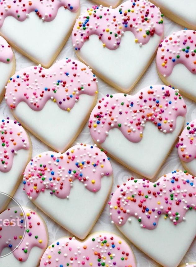 Charming Heart-Shaped Cookies with Pink Icing and Vibrant Sprinkles for Celebrations.