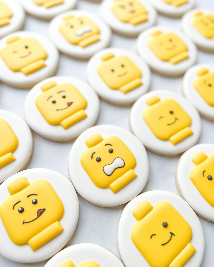 Playful Lego-Inspired Nail Art: Bright Yellow Designs with Cheerful Smiley Faces.