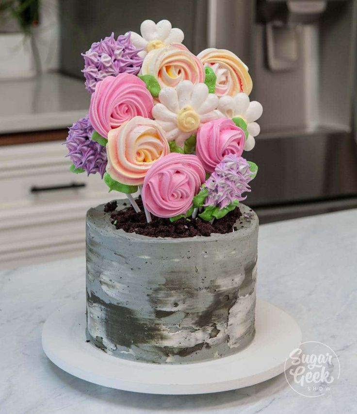 Whimsical Cake Elegantly Topped with Colorful Icing Flower Bouquet in Concrete Pot Design