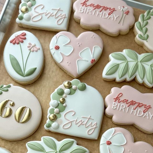 Floral and Script-Adorned Decorative Cookies in Soft Pastels for Celebrations.