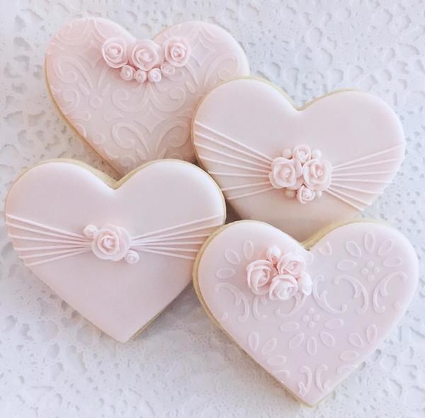 Romantic Heart-Shaped Cookies with Floral and Ribbon Icing Details