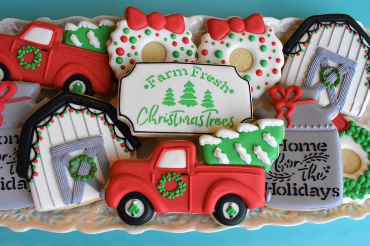 Festive Platter of Colorful Holiday Cookies Featuring Cheerful Red Trucks and Cookie Houses.