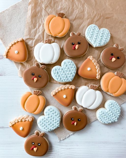 Beautifully Arranged Fall-Themed Decorative Cookies on a Rustic Surface