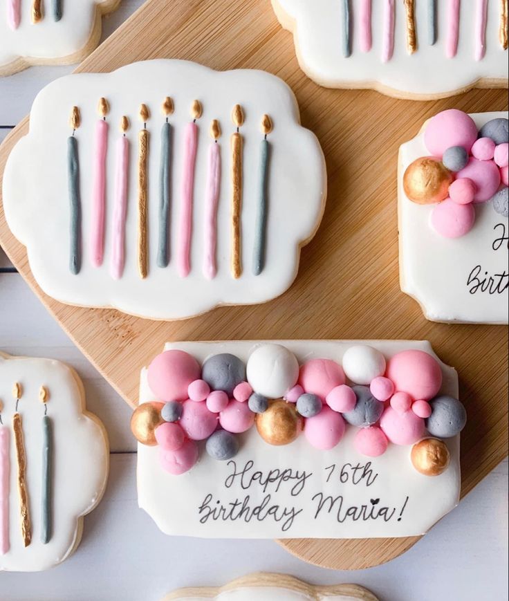 Whimsical Birthday Cookies: Colorful Icing and Fondant Designs with Festive Candle Motifs.