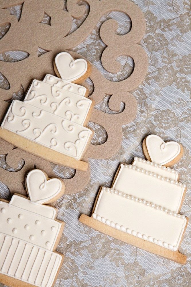 Charming Heart-Shaped Wedding Cake Cookies with Intricate Designs for Celebratory Occasions.