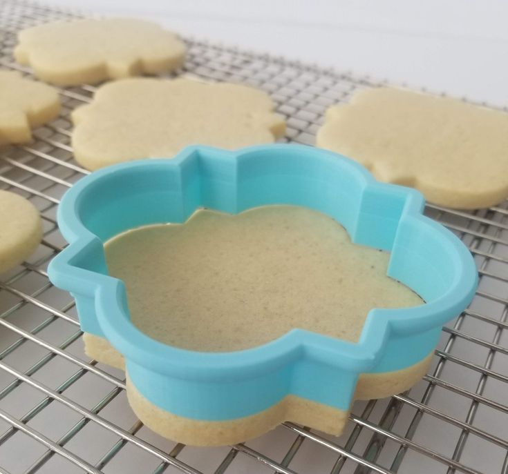 Whimsical Blue Cloud Shaped Cookie Cutter Amidst Golden-Brown Dough for Themed Celebrations