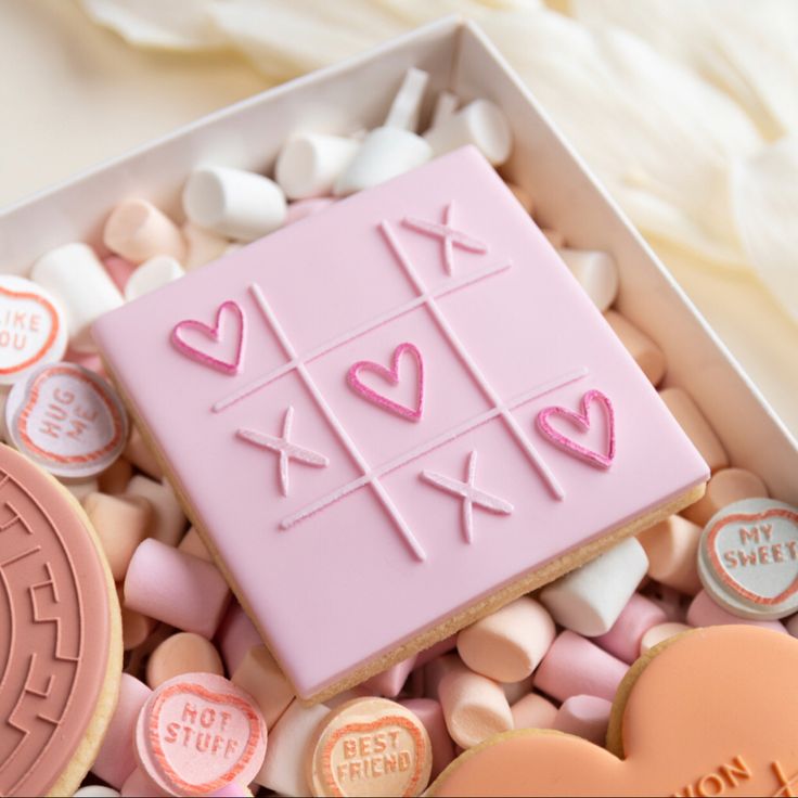 Whimsical Pastel Pink Tic-Tac-Toe Embossed Cookie with Hearts and Xs.